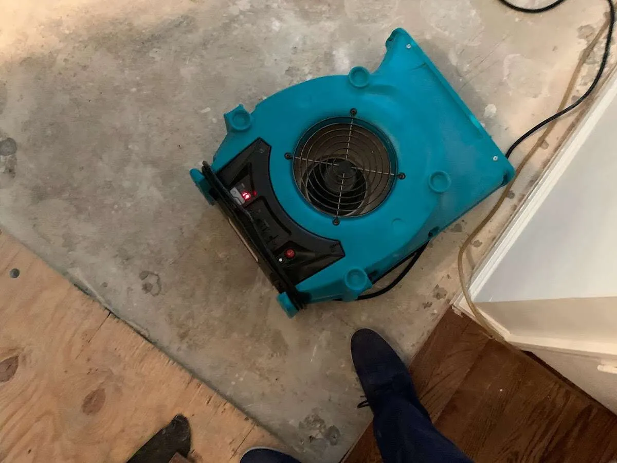 Air mover drying subfloor during Commercial Water Damage Restoration in Stonecrest